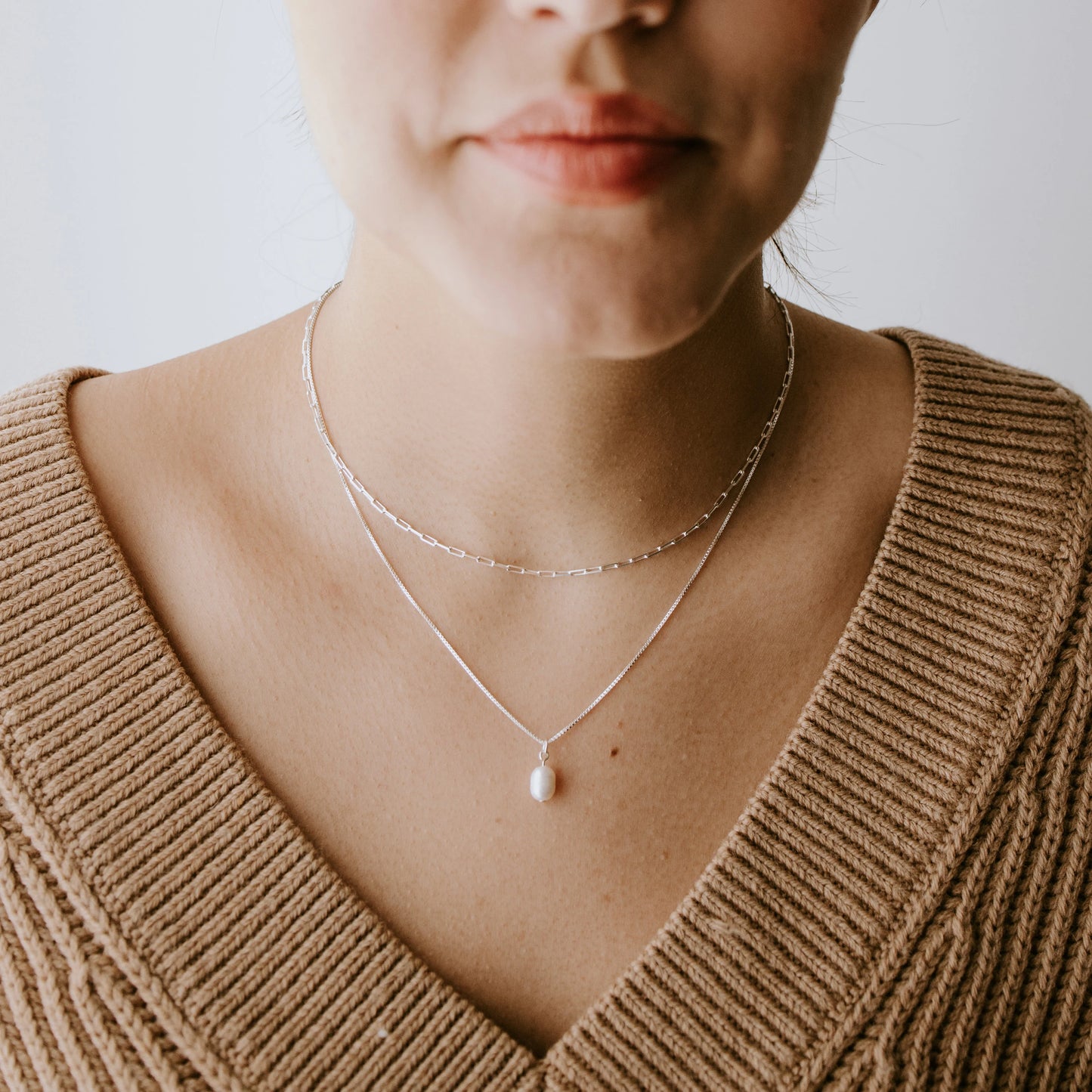 Minimal sterling silver pearl necklace featuring a genuine freshwater pearl pendant.