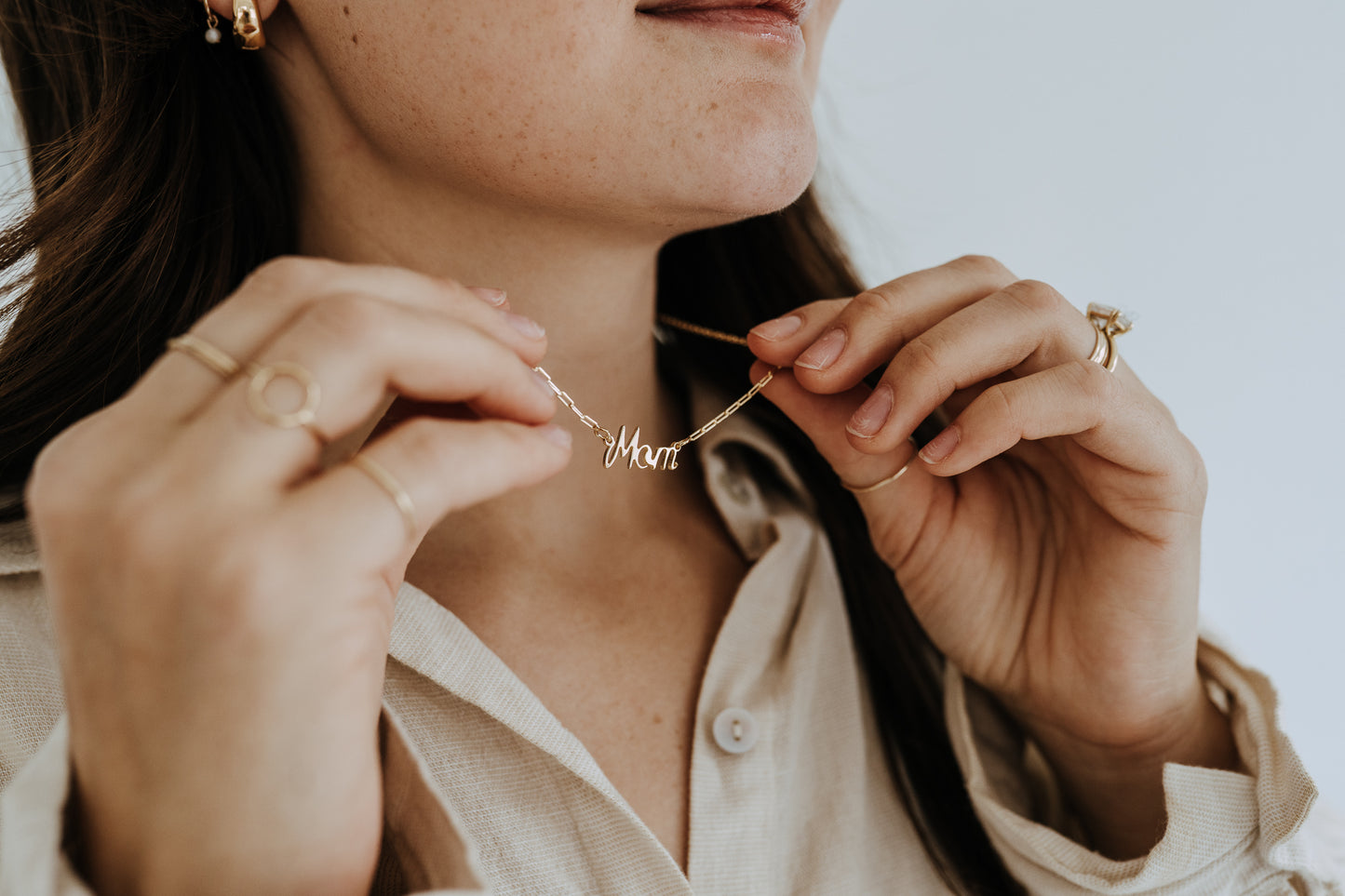 Delicate Mother's necklace crafted in 18k gold filled material with paperclip chain detail.