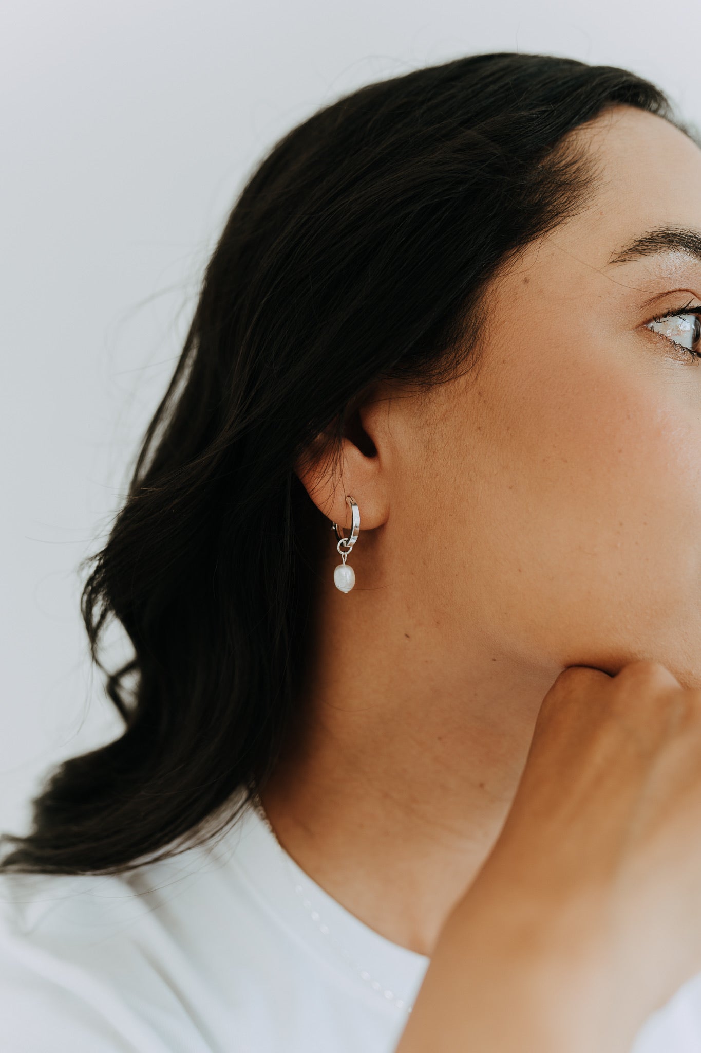 Timeless sterling silver pearl hoop earrings with natural freshwater pearl drops for everyday wear.