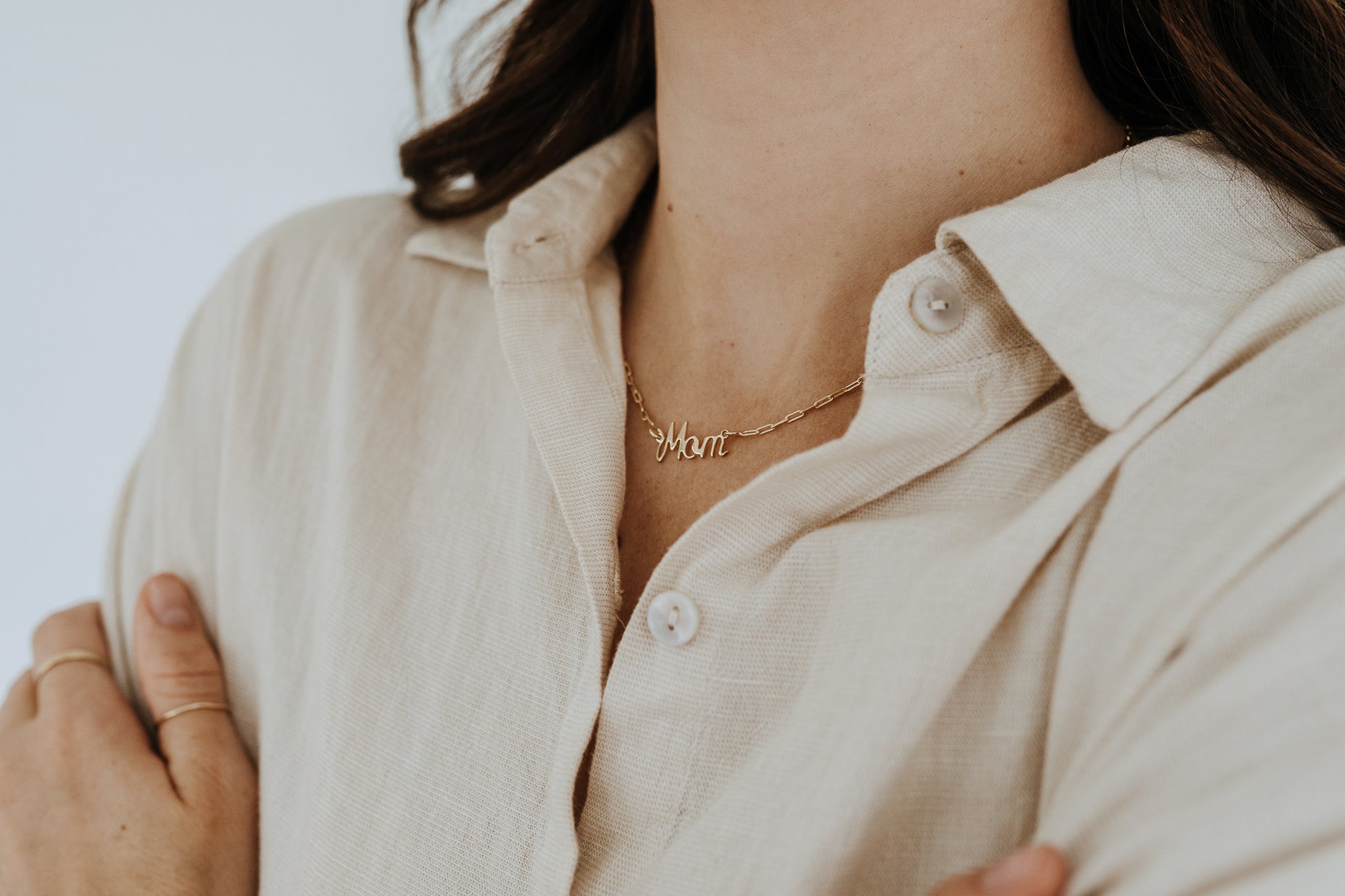 Script Mom necklace on a dainty paperclip chain styled as an everyday Mother's Day gift.