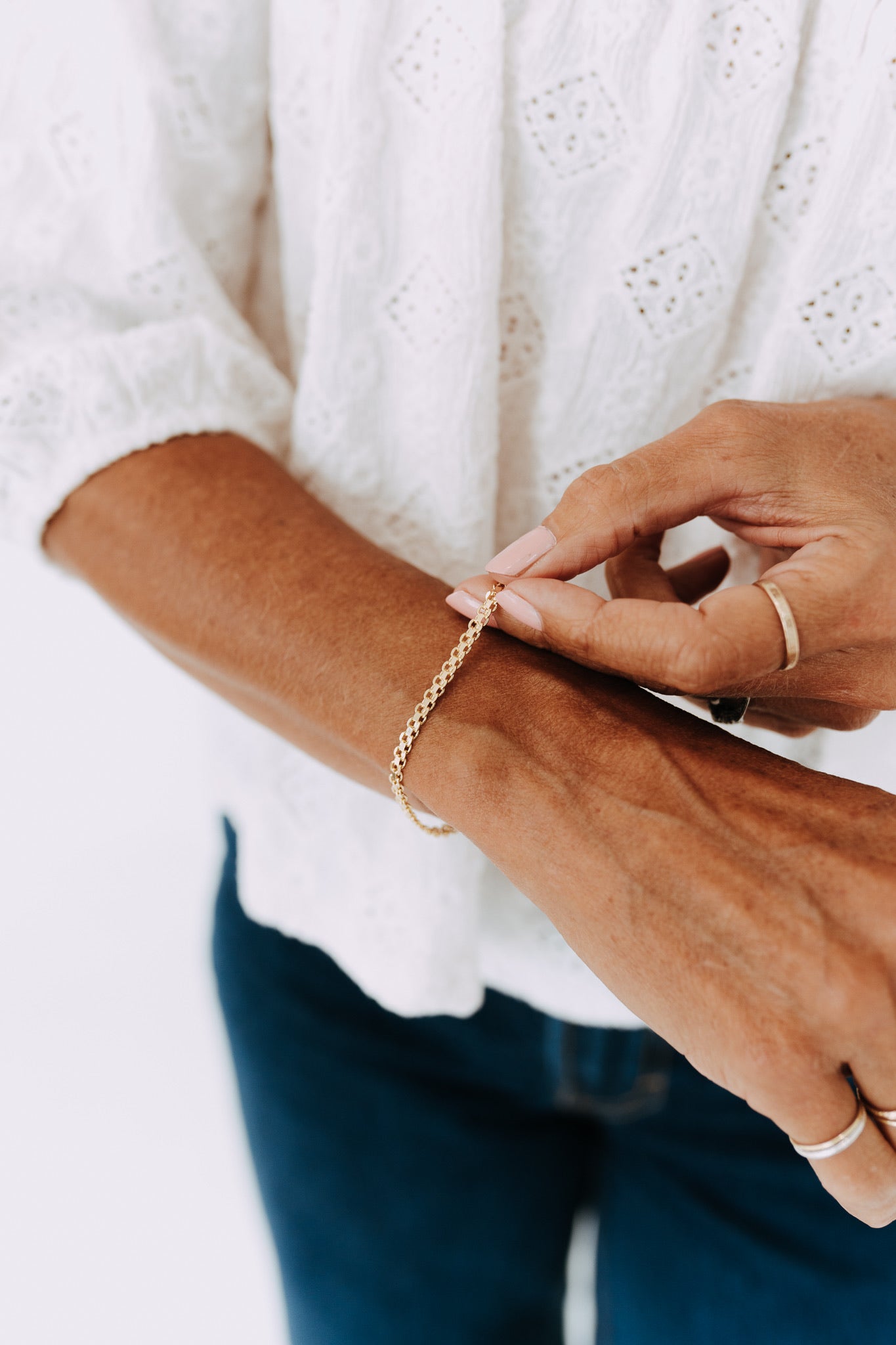 Gold filled Marlow bracelet styled on wrist with everyday jewelry