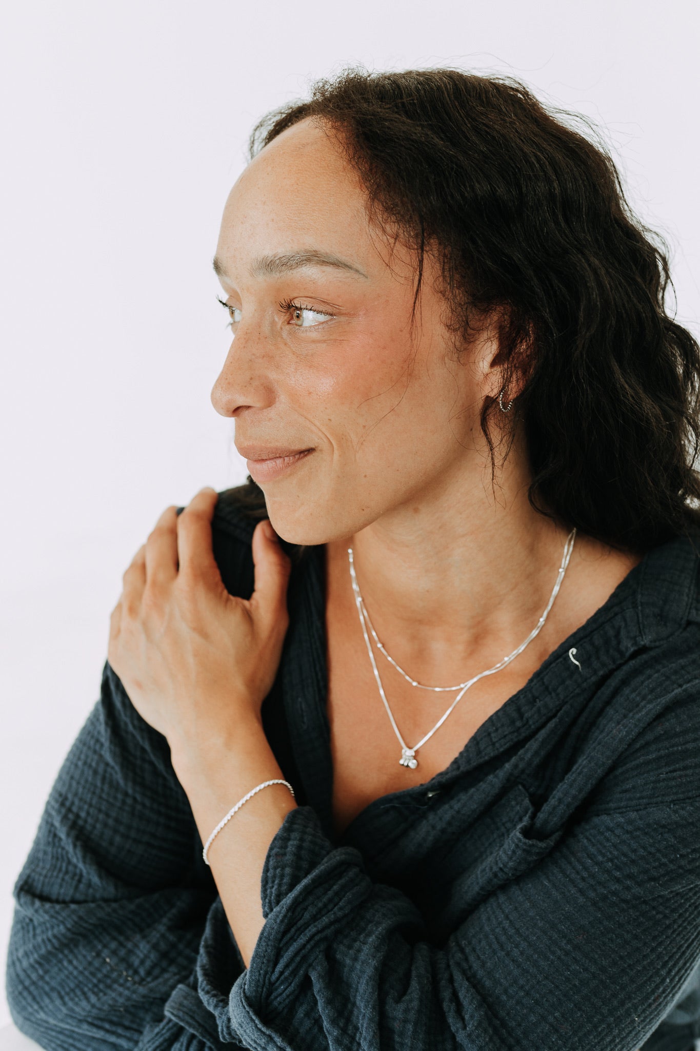 Sterling silver birthstone necklace layered with a satellite chain.