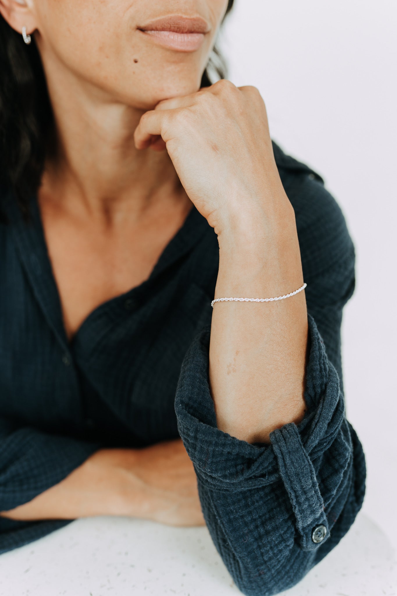 Sterling silver rope bracelet with delicate twisted chain on woman's wrist