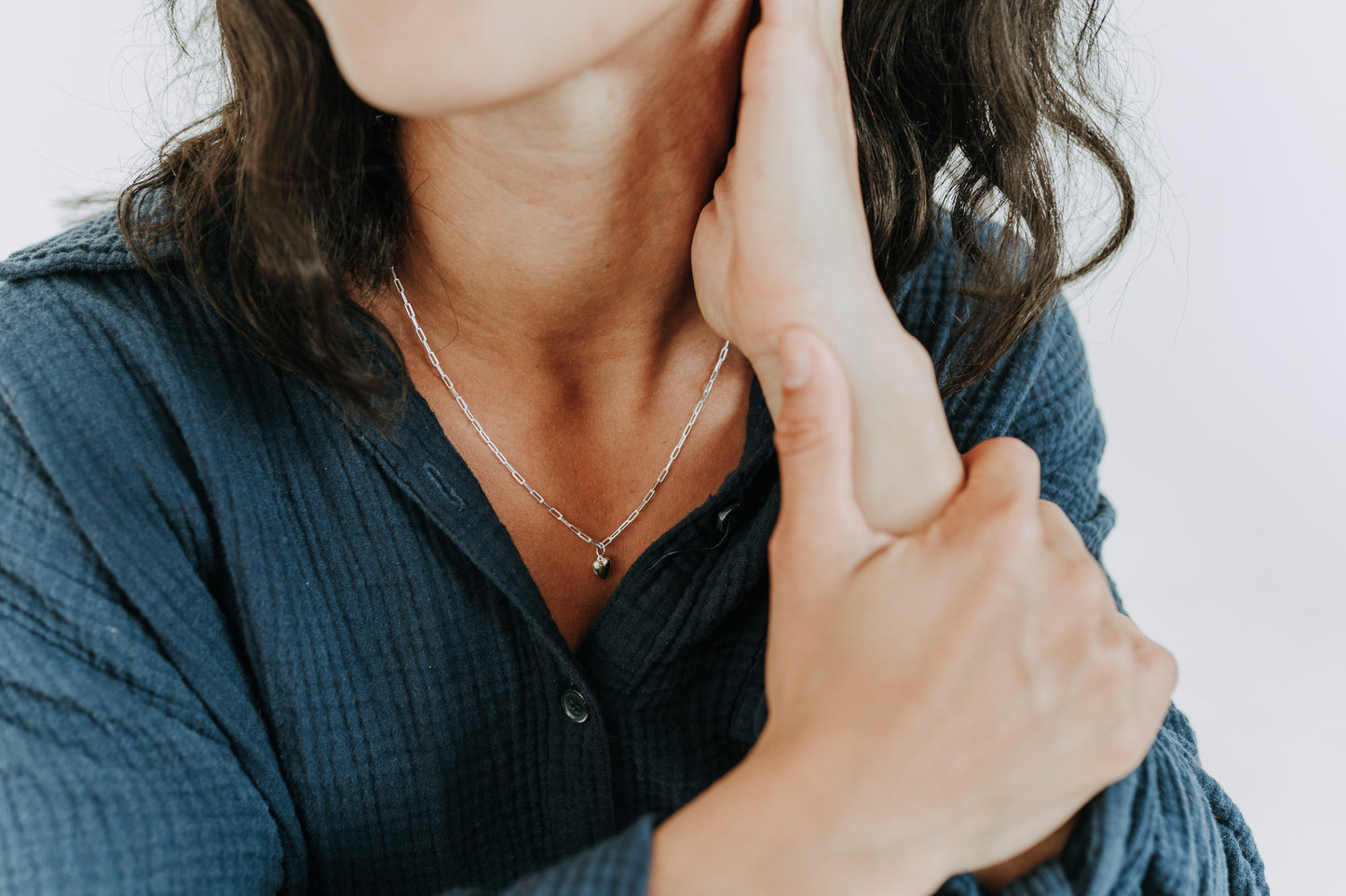 Minimalist sterling silver heart necklace designed for layering and everyday wear
