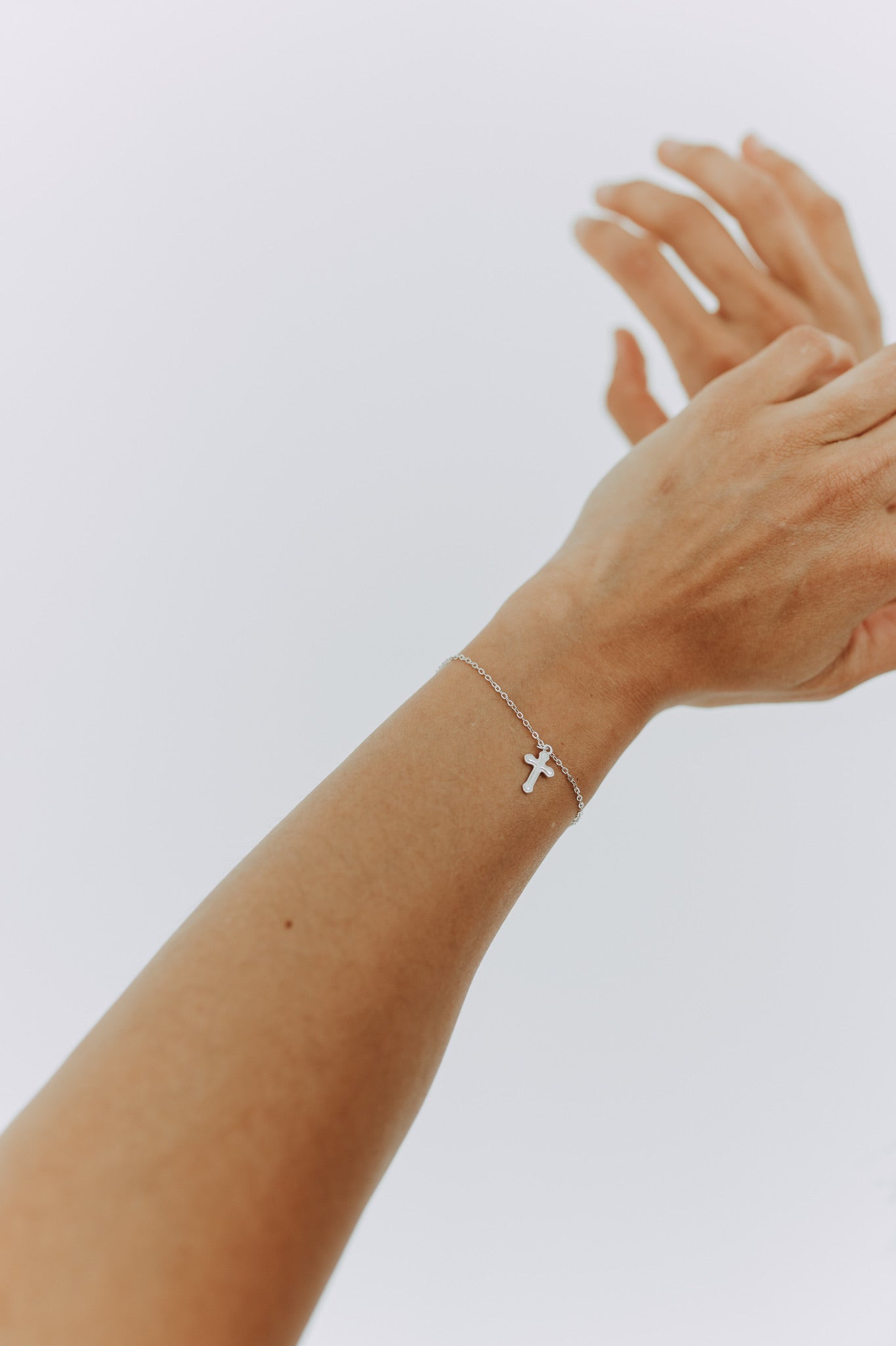 Sterling silver faith bracelet featuring a delicate cross charm.