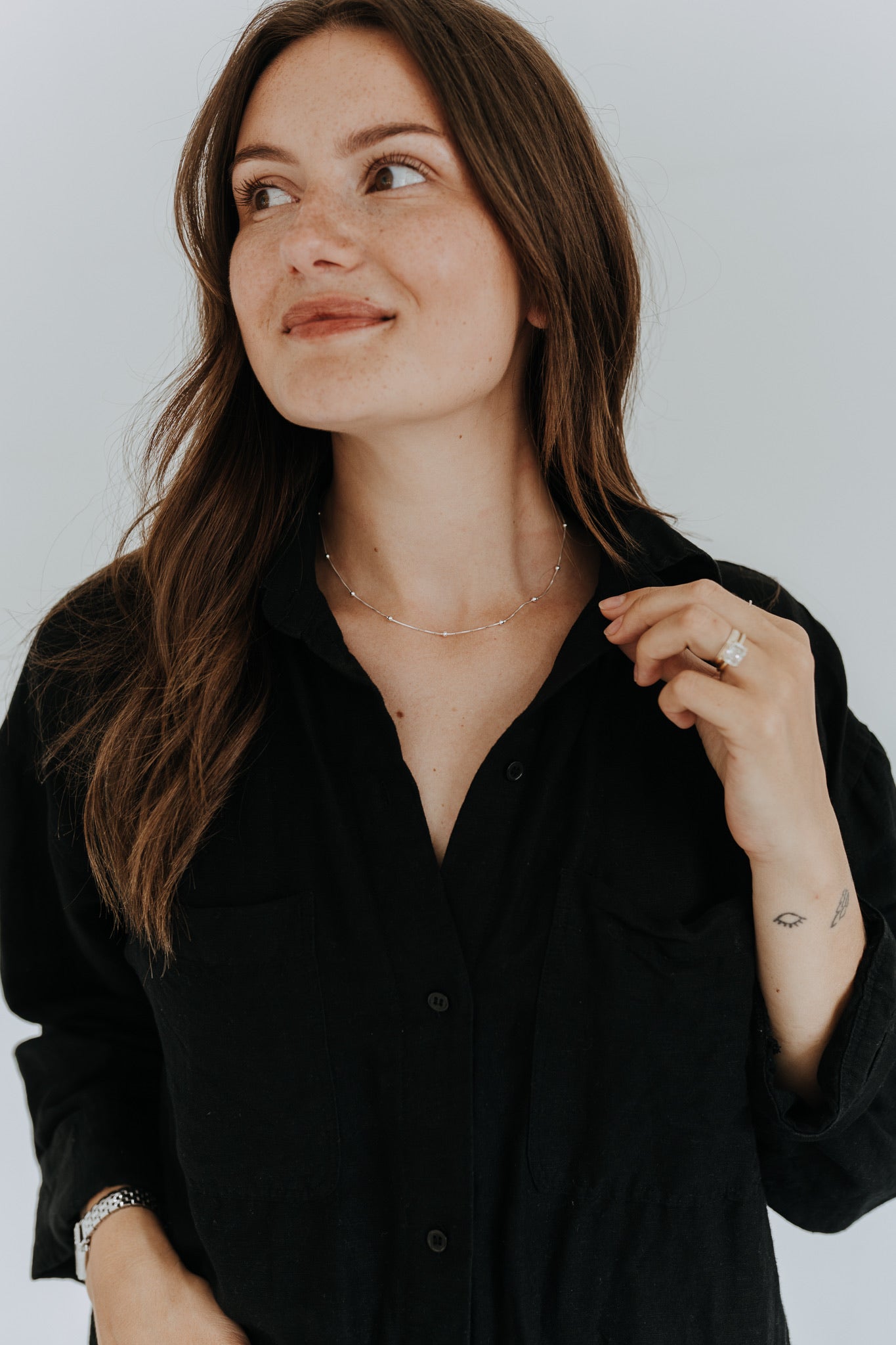 Sterling silver satellite chain necklace layered alone for an elegant everyday look.