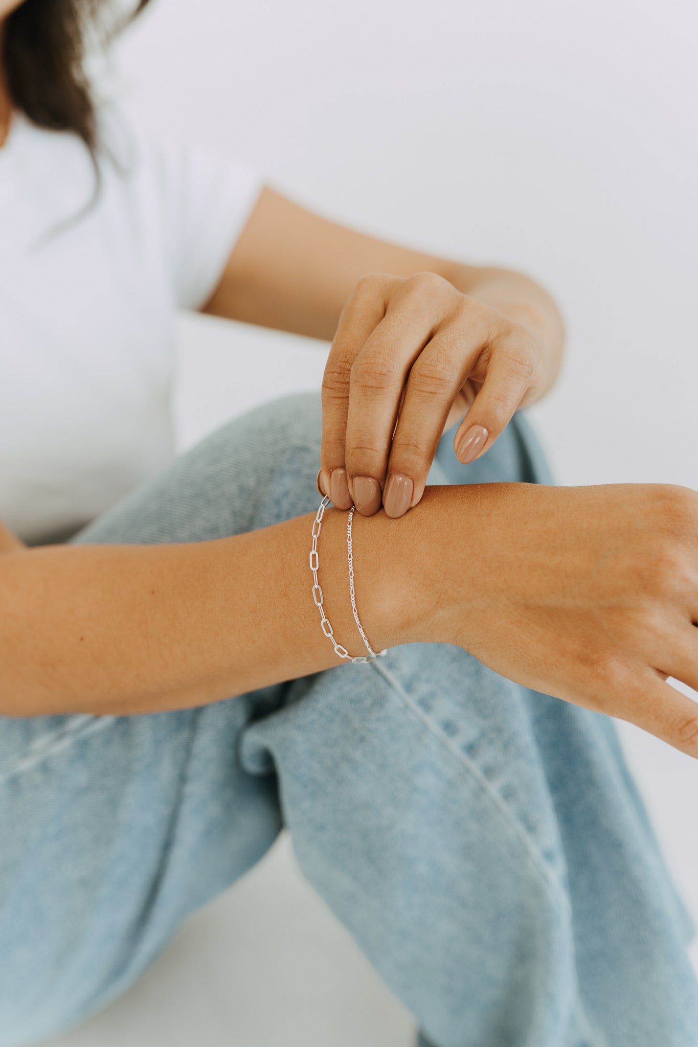Close-up of sterling silver double chain bracelet on woman's wrist.