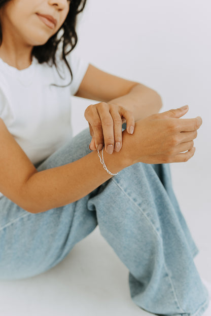 Sterling silver Figaro and Paperclip bracelet styled with casual denim.