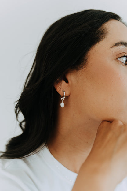 Timeless sterling silver pearl hoop earrings with natural freshwater pearl drops for everyday wear.
