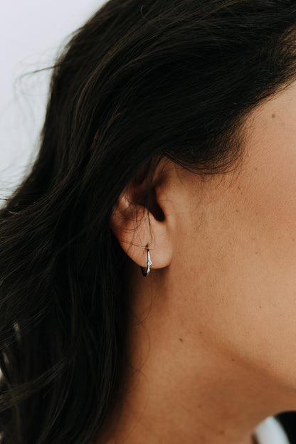 Close-up of sterling silver Bay Hoops with polished finish and delicate CZ detail.