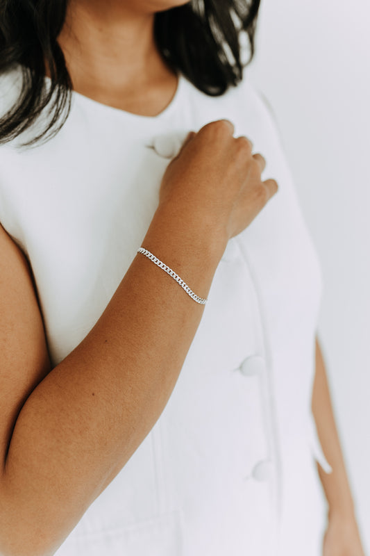 Sterling silver 3.5mm curb chain bracelet worn on wrist.