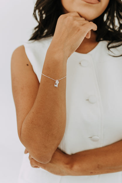 Dainty sterling silver bracelet featuring lock and key charms