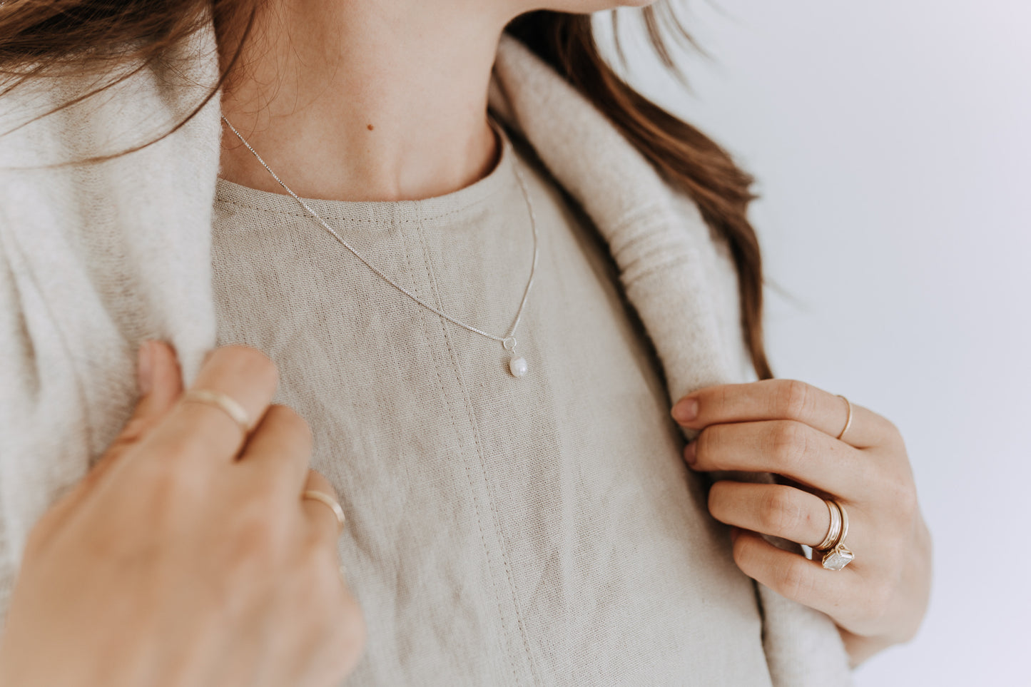 Minimal sterling silver pearl necklace featuring a genuine freshwater pearl pendant.