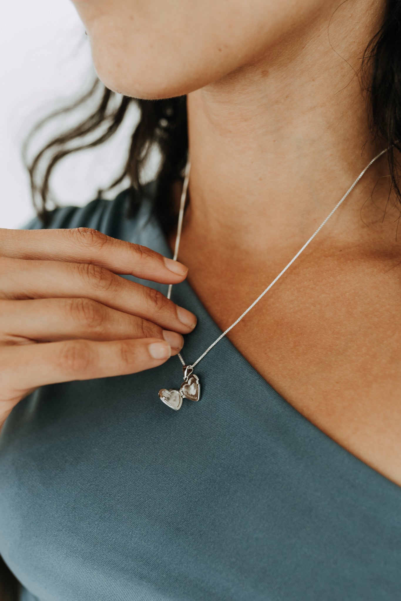 Open sterling silver heart locket showing space for two small photos.