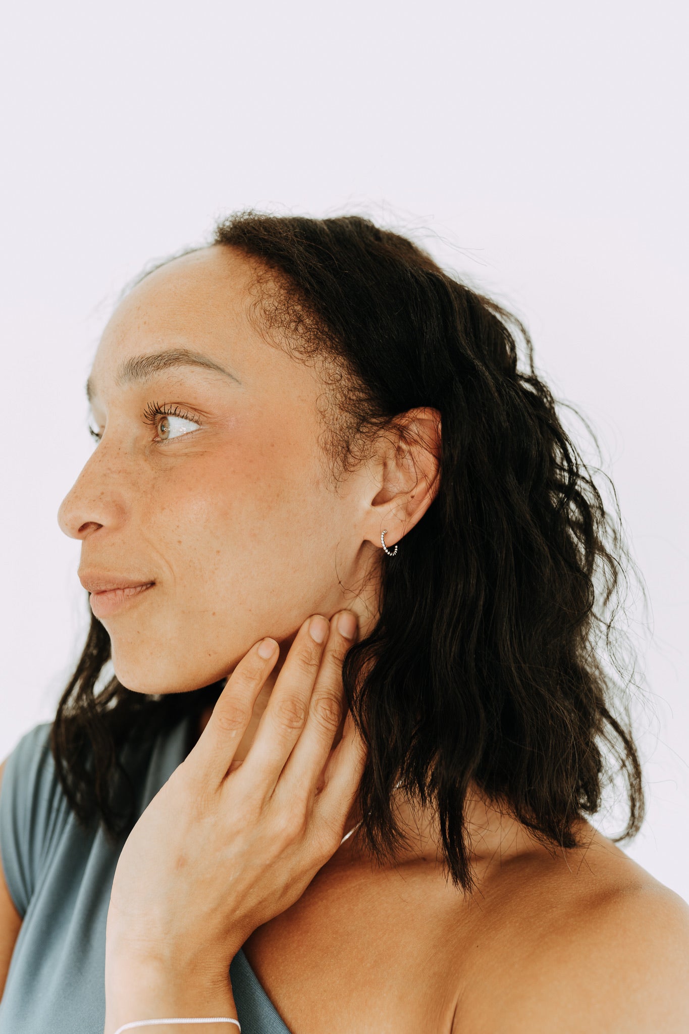 Everyday sterling silver huggie hoops featuring delicate beaded texture.