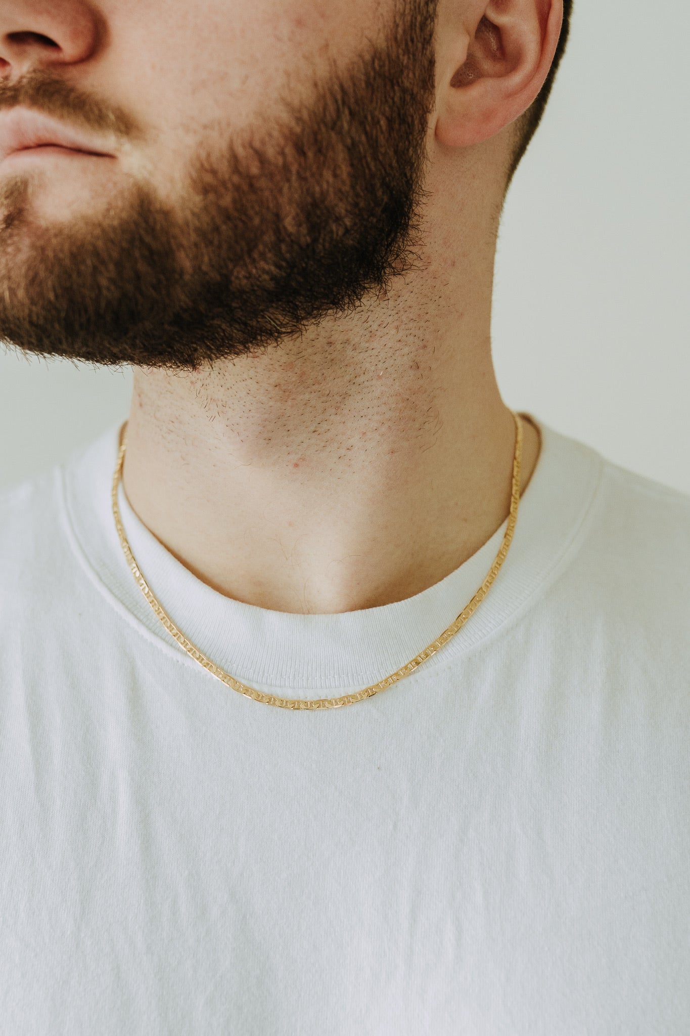 Waterproof gold filled men’s necklace layered over classic white t-shirt