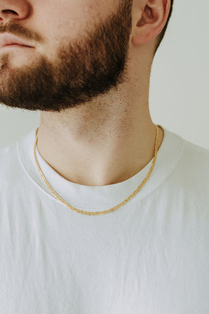 Waterproof gold filled men’s necklace layered over classic white t-shirt