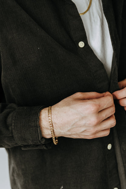 Tarnish-resistant gold curb bracelet for men styled casually with everyday basics