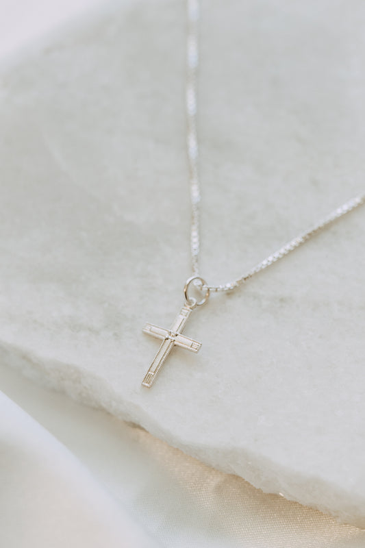 Minimal sterling silver cross pendant necklace close-up