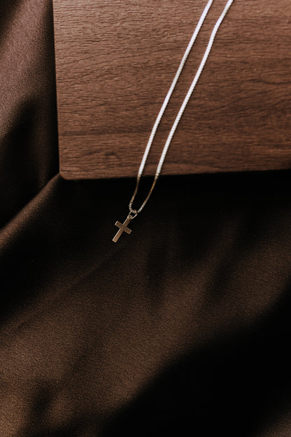 Tiny sterling silver cross necklace for men with sleek simple styling