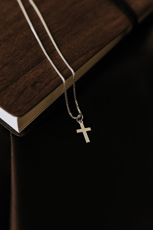 Minimal silver cross necklace for men close-up on silver chain