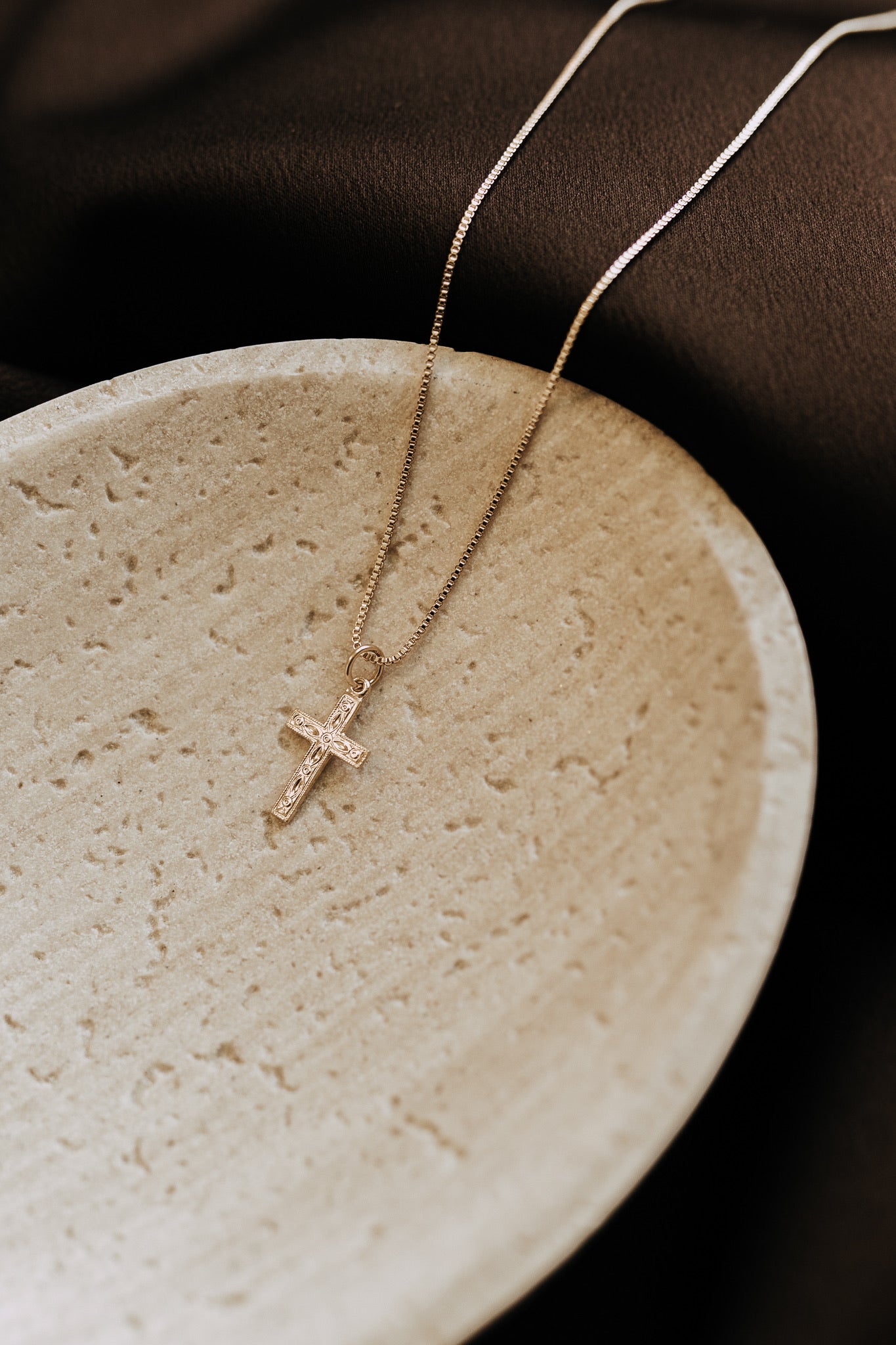 Minimalist gold cross necklace with heirloom-inspired detailing