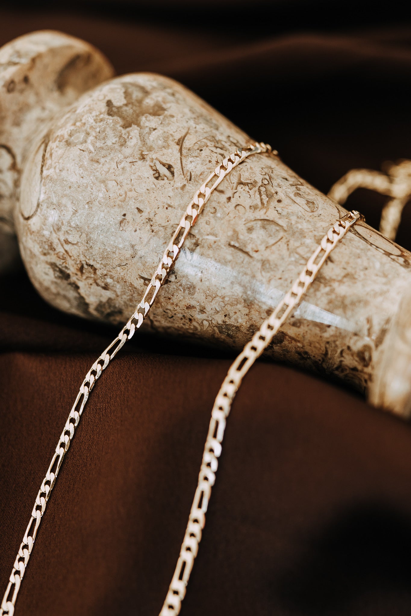 Close-up of 18k gold filled Figaro chain necklace for men with polished flat links