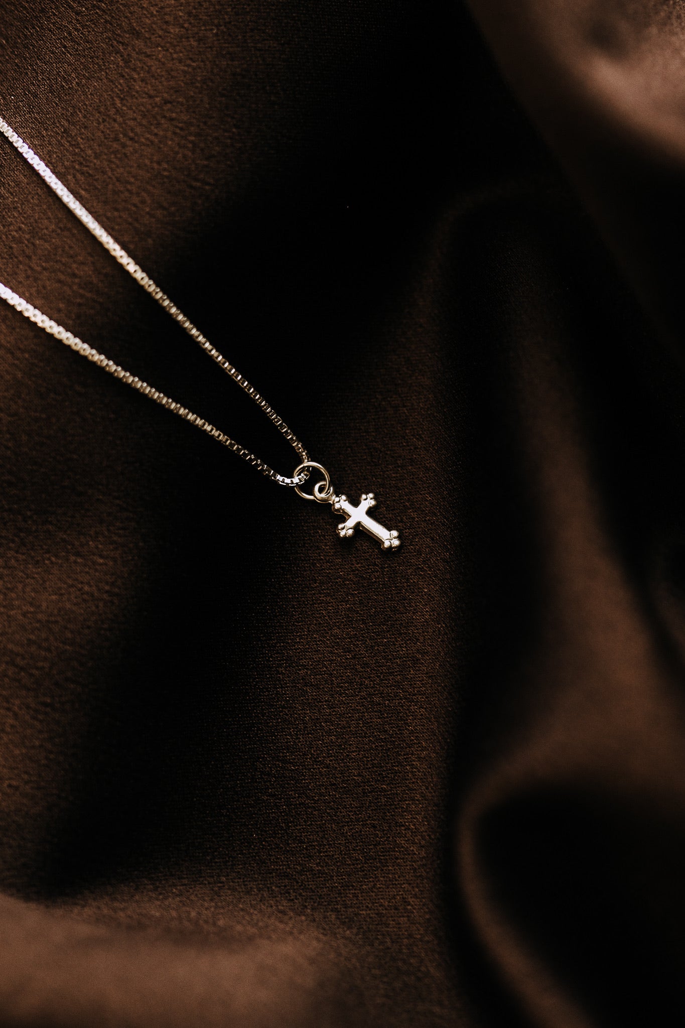 Dainty sterling silver cross necklace on delicate box chain
