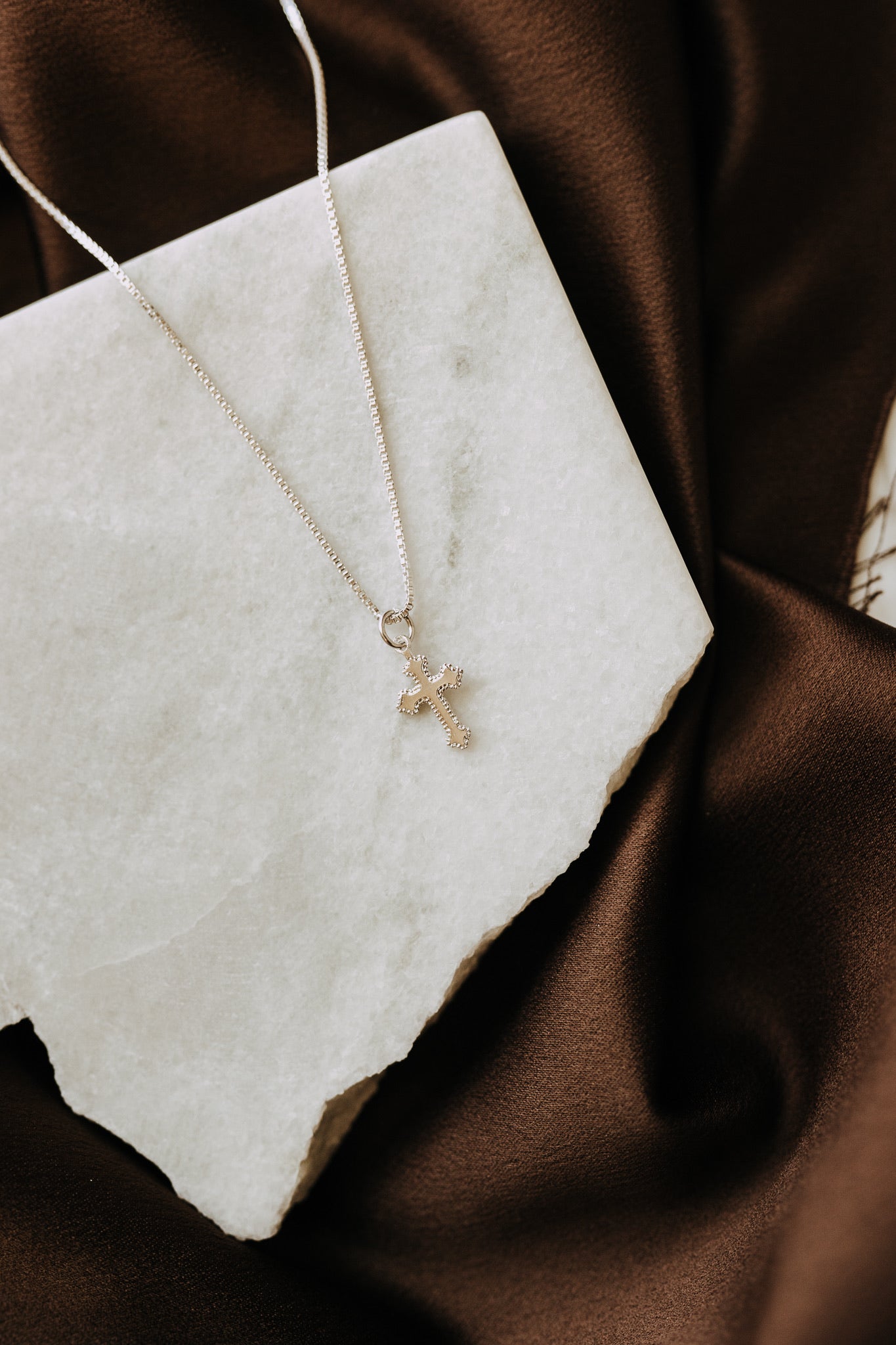 Detailed sterling silver cross pendant on box chain