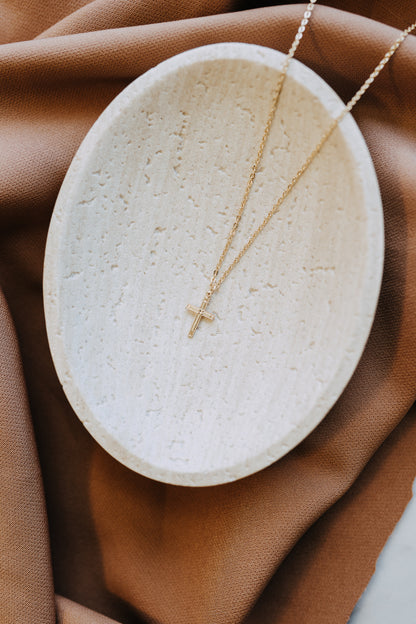 Tiny gold cross necklace on classic cable chain