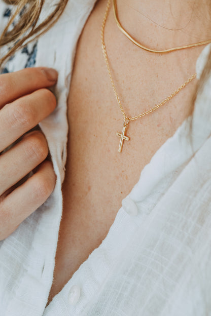 Minimal gold cross pendant necklace styled for everyday wear