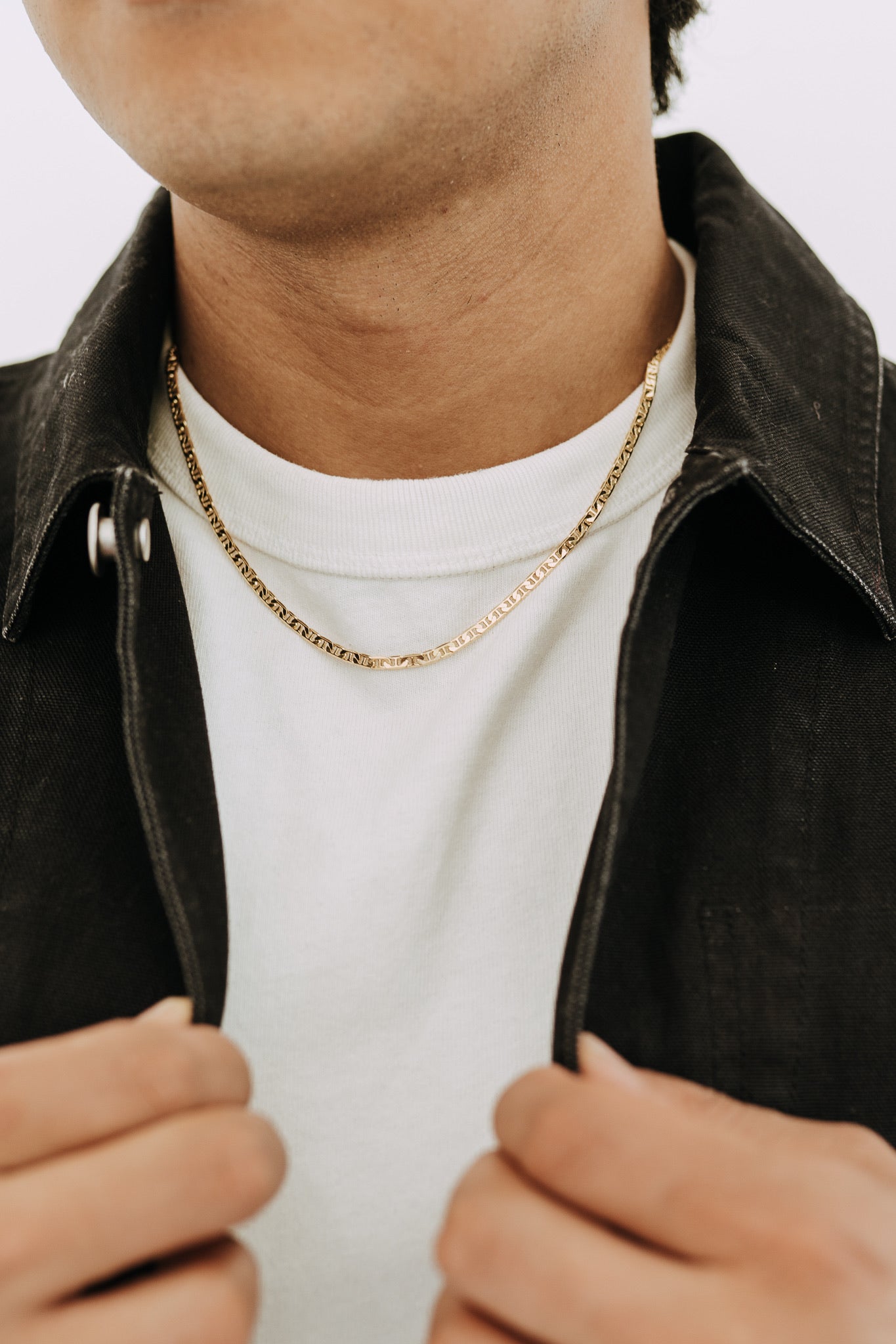 Men’s 18k gold filled Roma chain necklace styled with black jacket and white tee