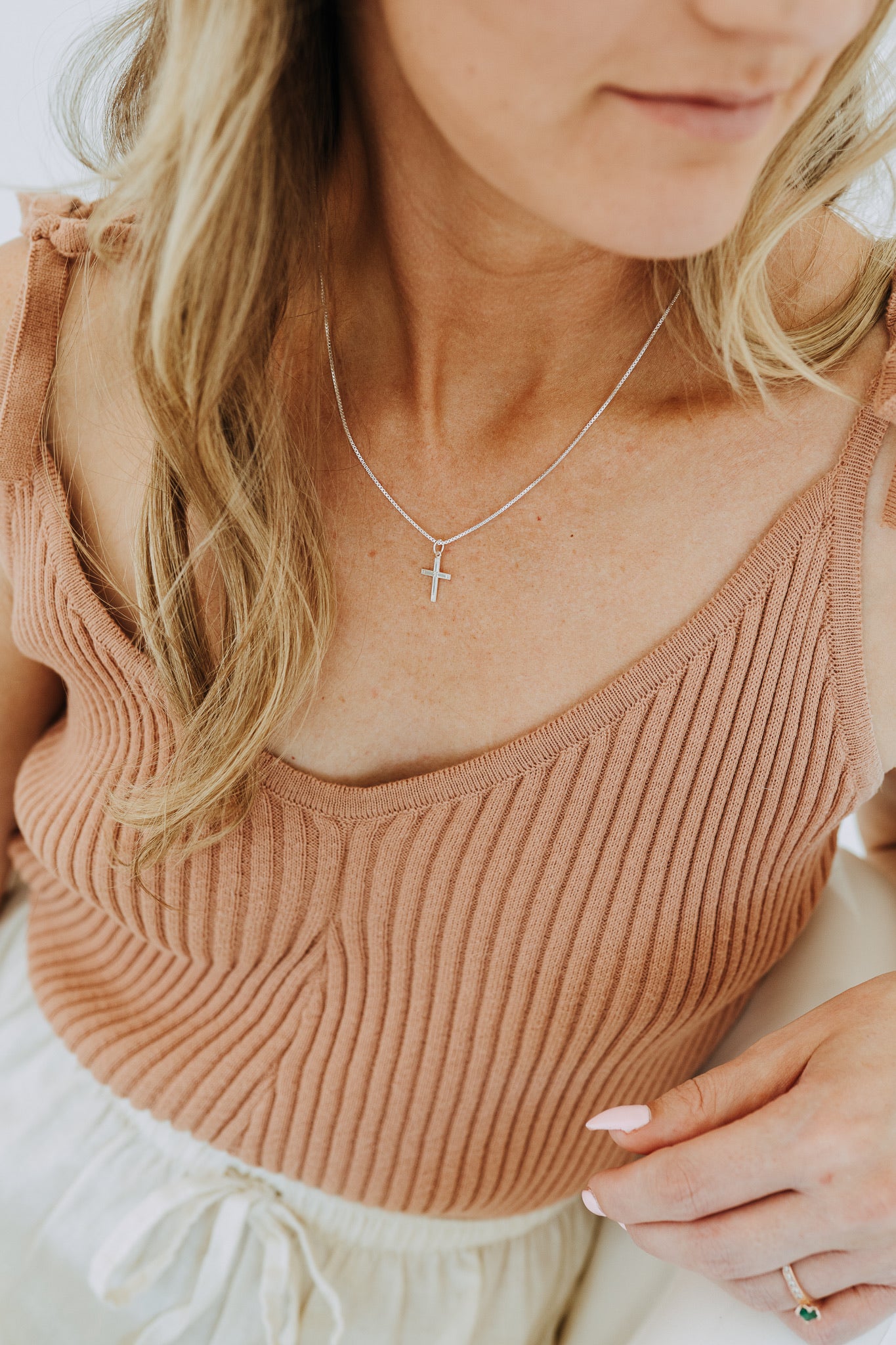 Minimalist sterling silver faith necklace on model
