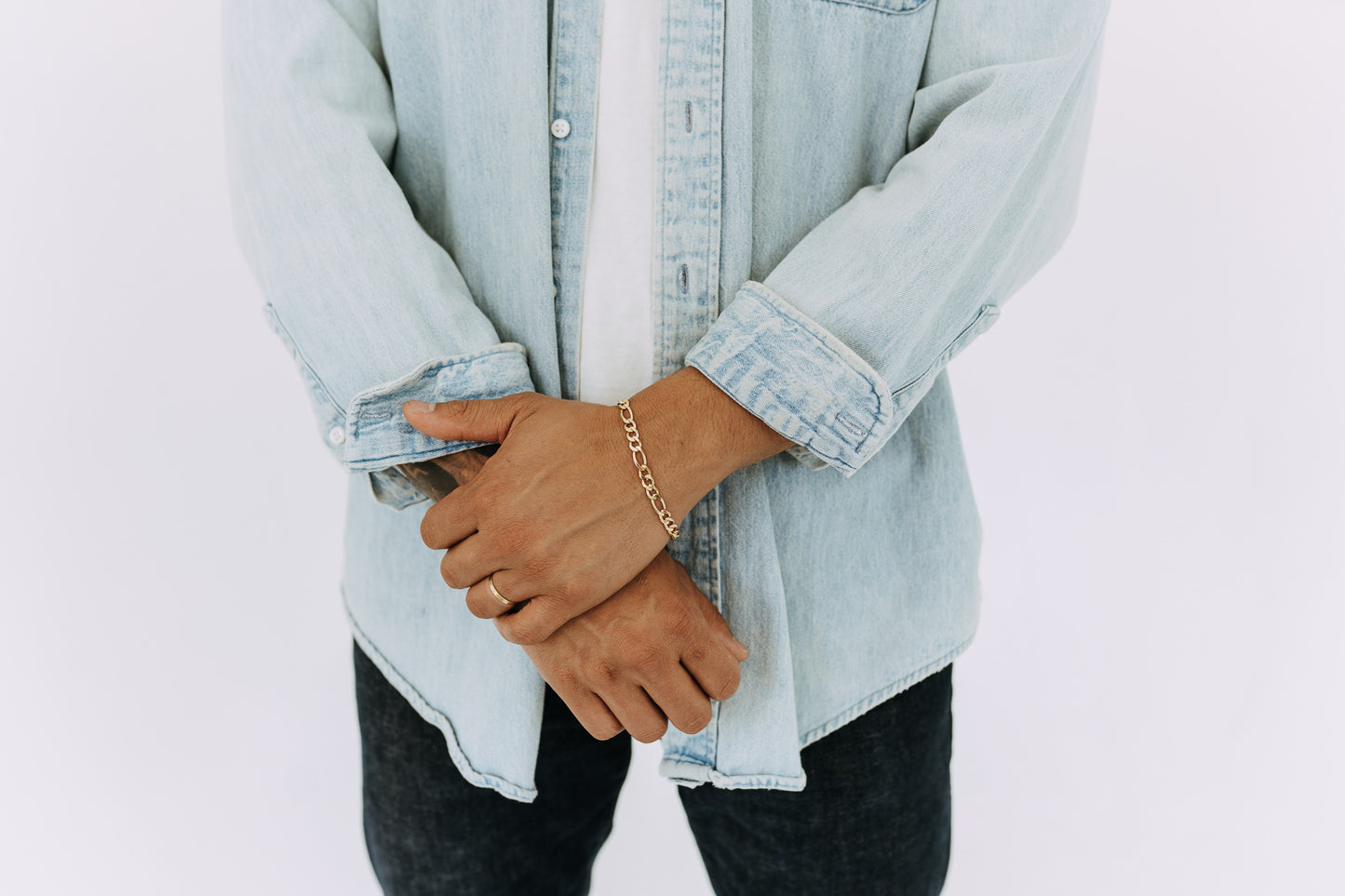 Waterproof gold Figaro bracelet for men styled with relaxed casual streetwear