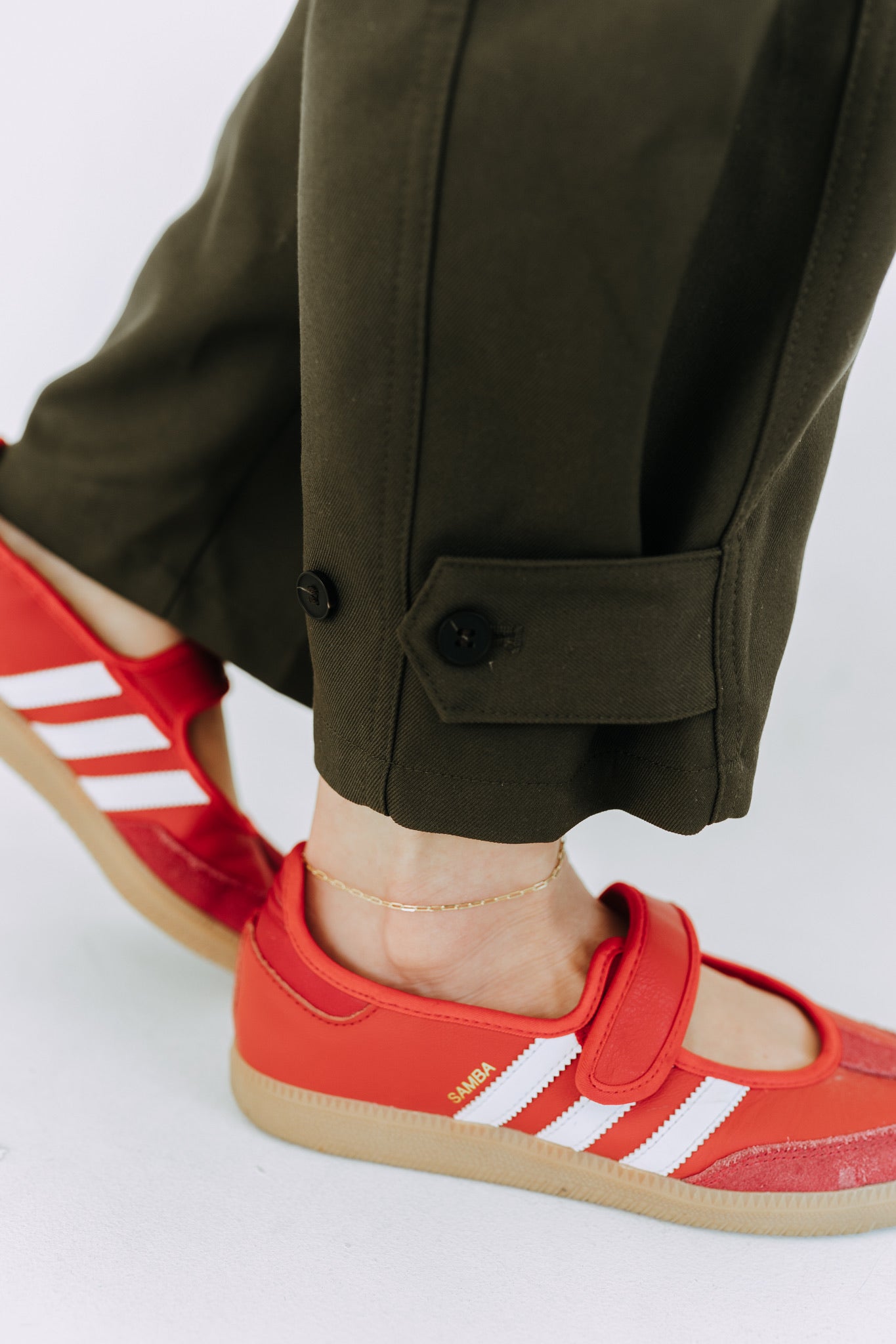 Delicate gold filled paperclip anklet layered with casual streetwear look