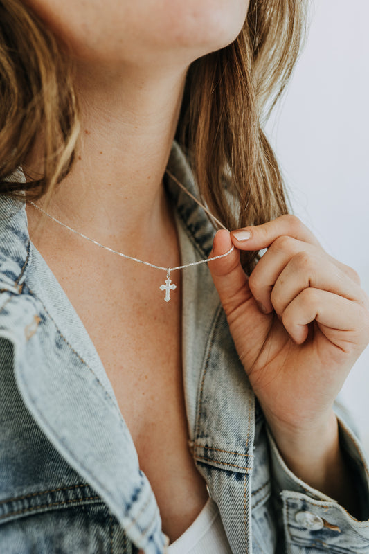 Sterling silver heirloom cross necklace on delicate box chain
