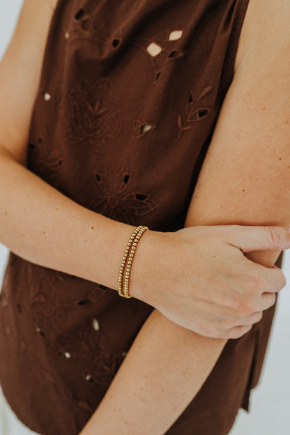 Close-up of stackable gold filled bead bracelet with polished round beads