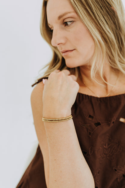 Waterproof gold bead bracelet styled casually for everyday jewelry looks