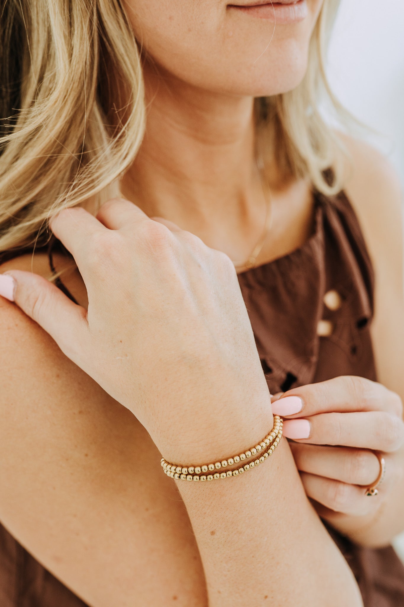 4mm gold filled bead bracelet stacked on wrist with minimal everyday styling