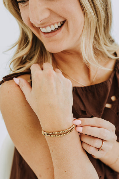 Stretch gold bead bracelet in polished 18k gold filled finish for layering