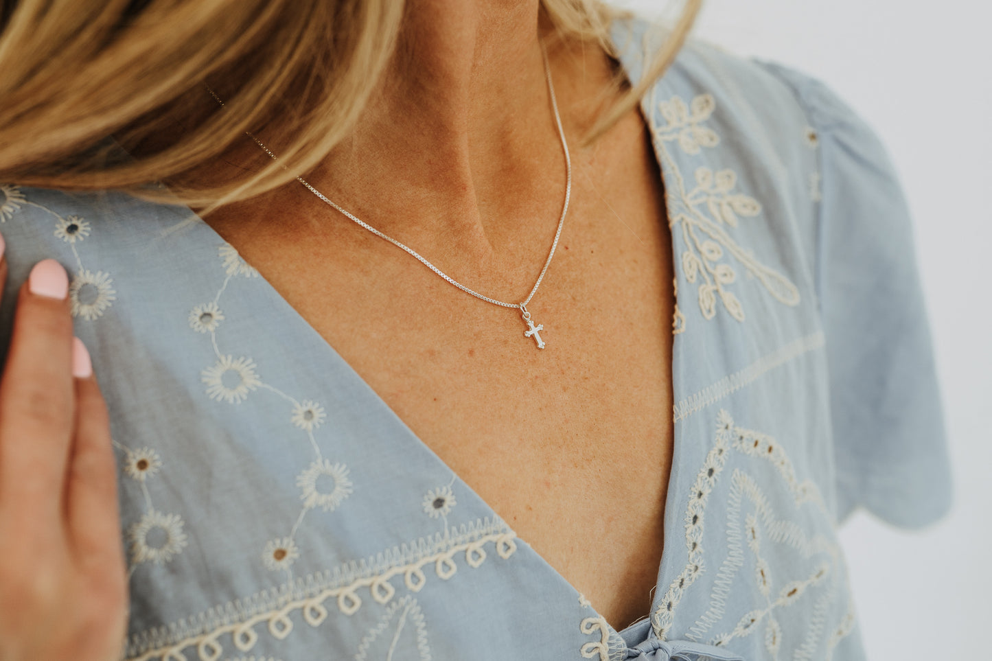 Minimal sterling silver cross necklace designed for everyday wear