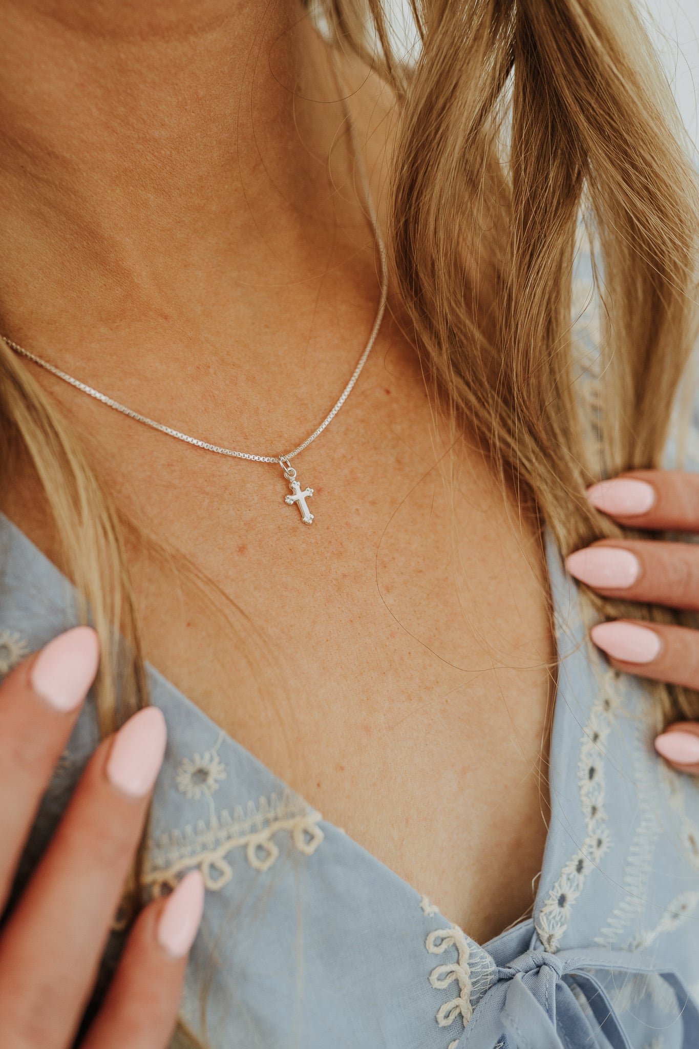 Everyday sterling silver faith necklace styled with blue blouse