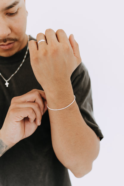 Minimal sterling silver rope bracelet worn on men's wrist