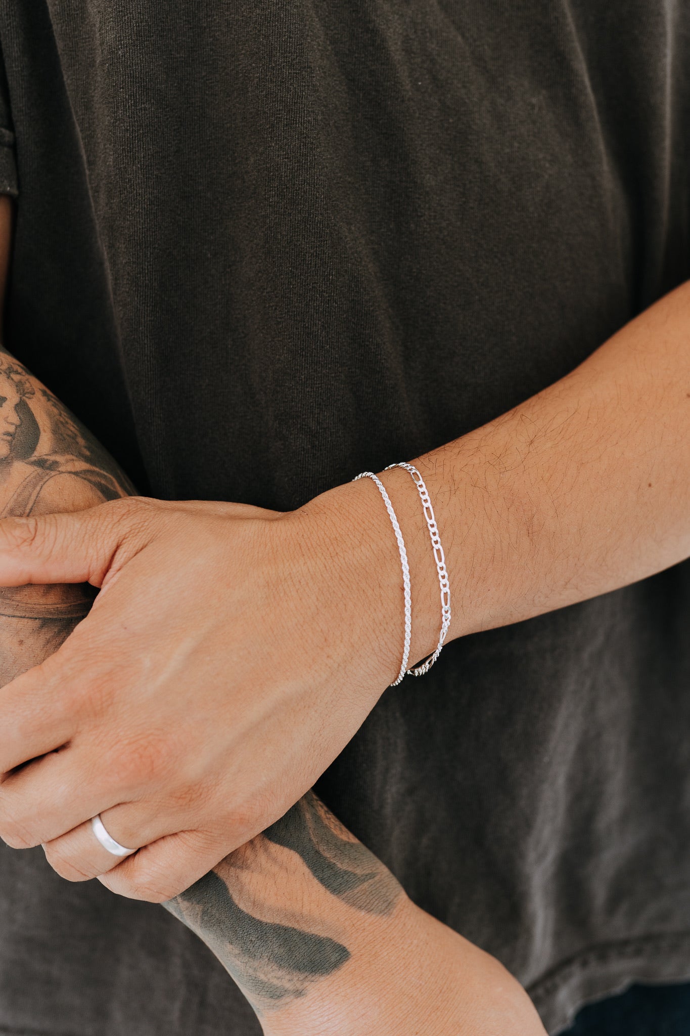 Men's sterling silver rope bracelet styled with silver Figaro bracelet