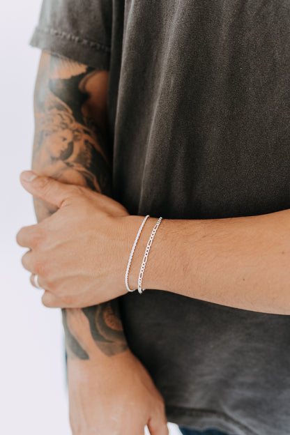 Sterling silver Figaro bracelet layered with other silver bracelets
