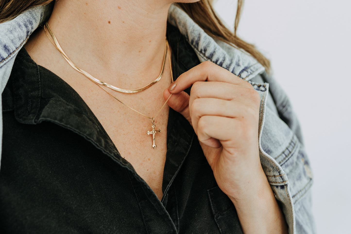 Close-up of detailed gold legacy cross pendant
