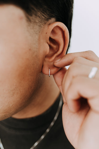 Lightweight sterling silver huggie hoop earring designed for comfortable daily wear.