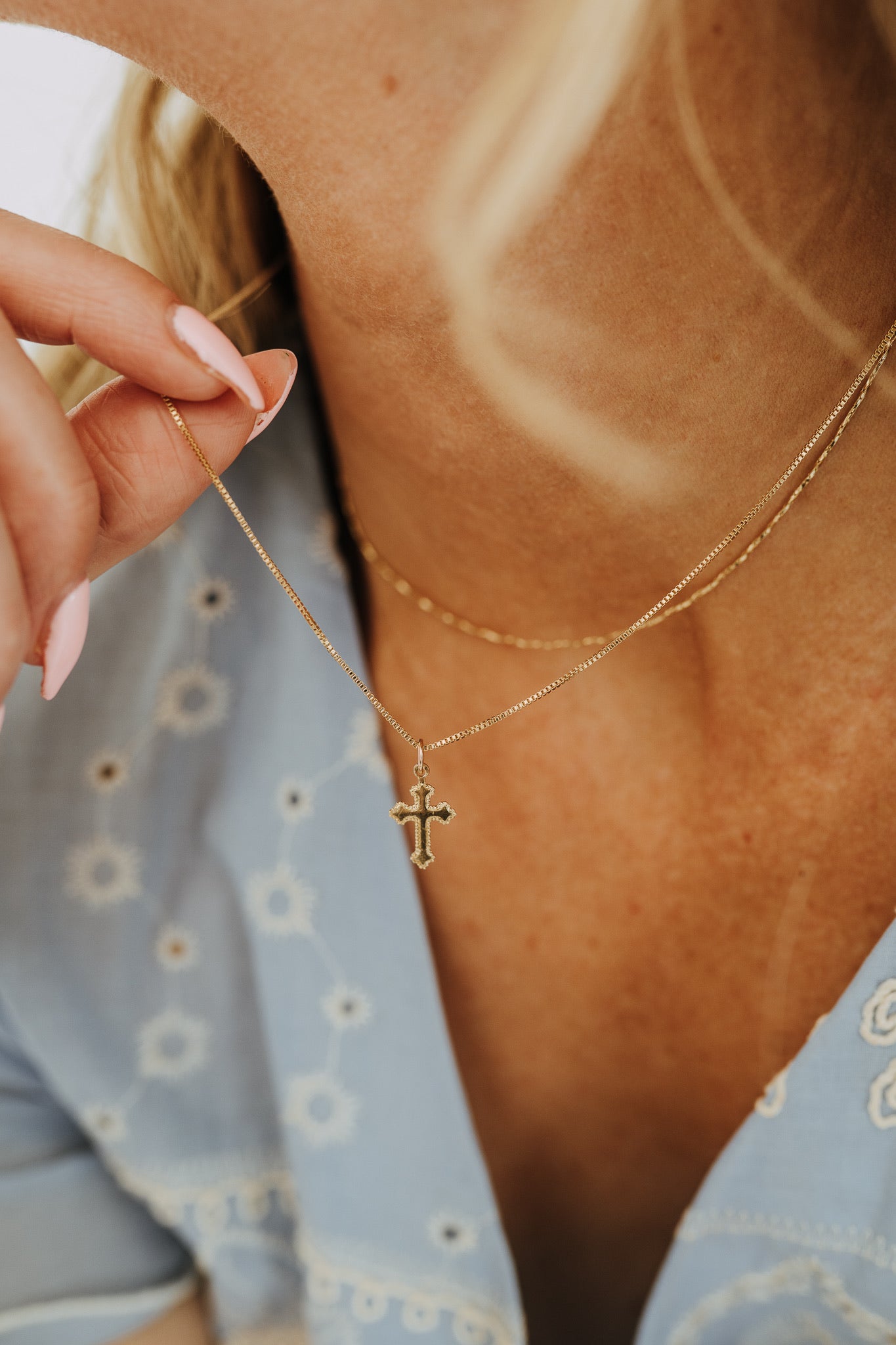 Vintage-inspired gold cross necklace on delicate box chain