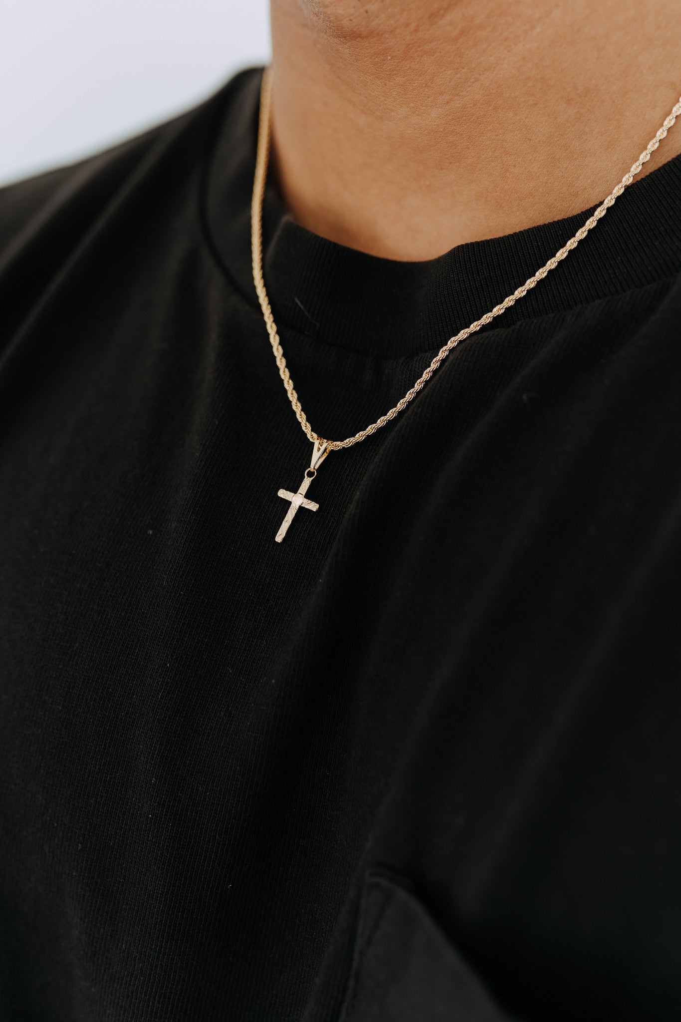Everyday men’s cross necklace styled with casual streetwear and minimalist gold jewelry