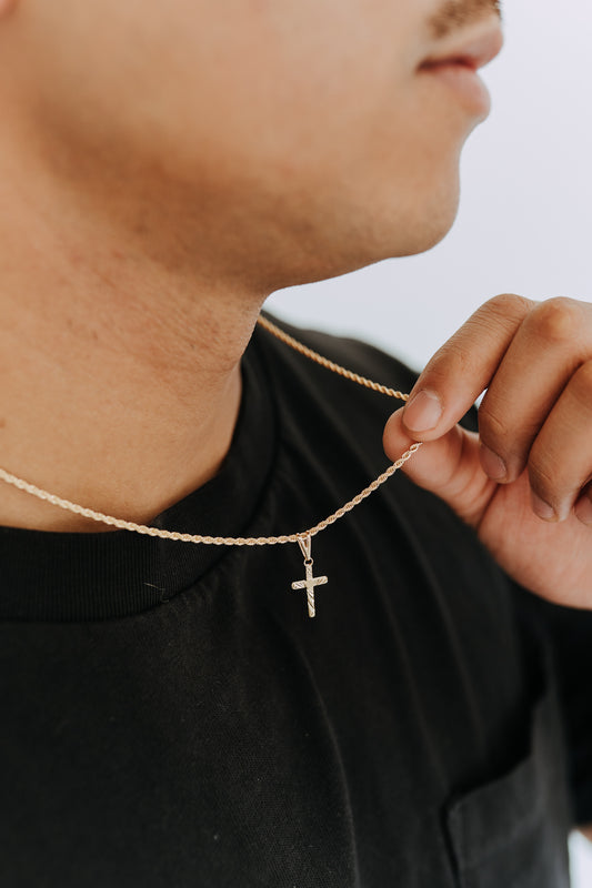 Men’s etched cross pendant necklace on a twisted rope chain styled with a black oversized tee